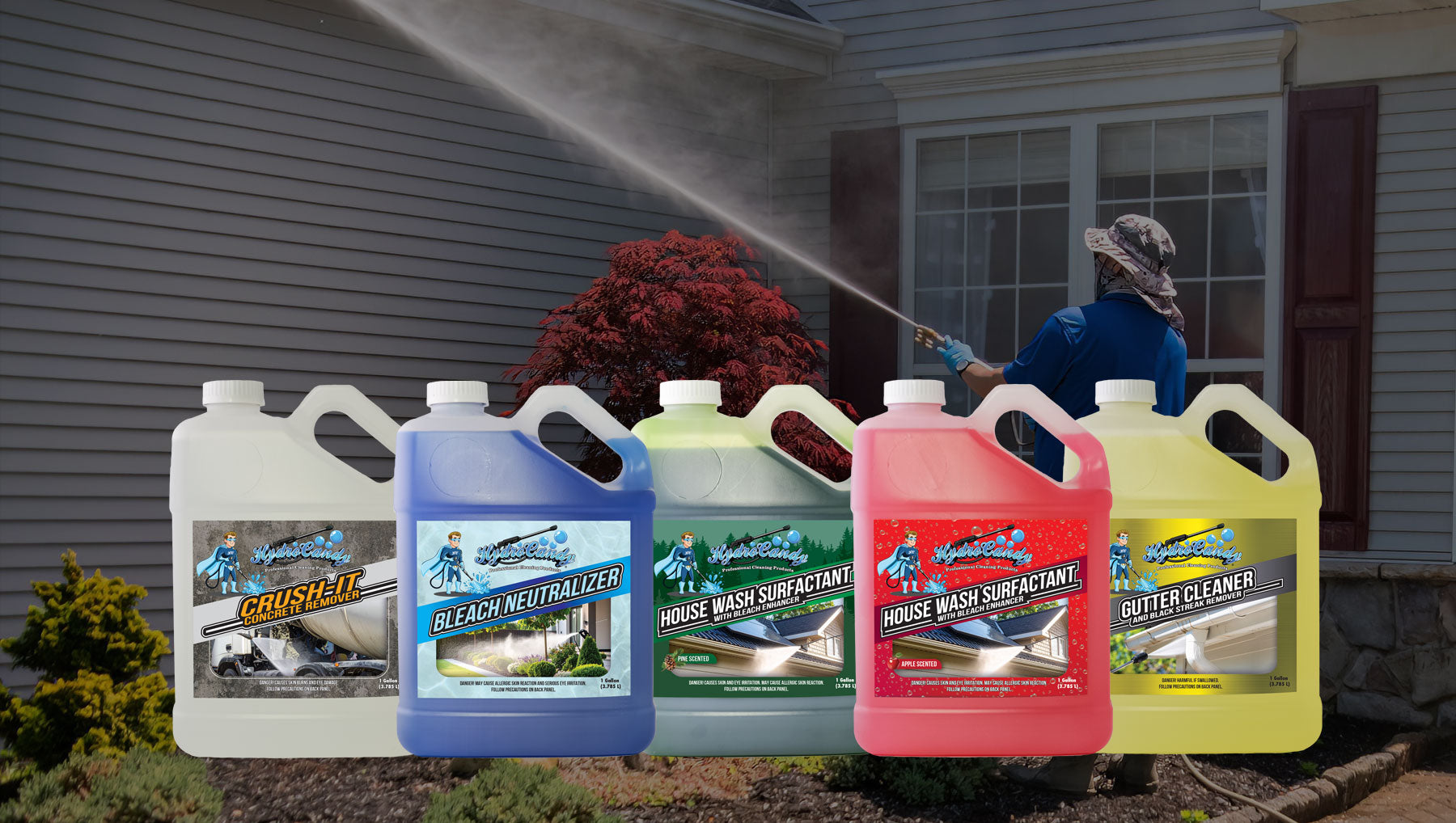 Collection of pressure washing products with a person using a hose in the background.